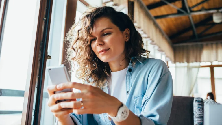 clinical study participant looking study locations on her smartphone